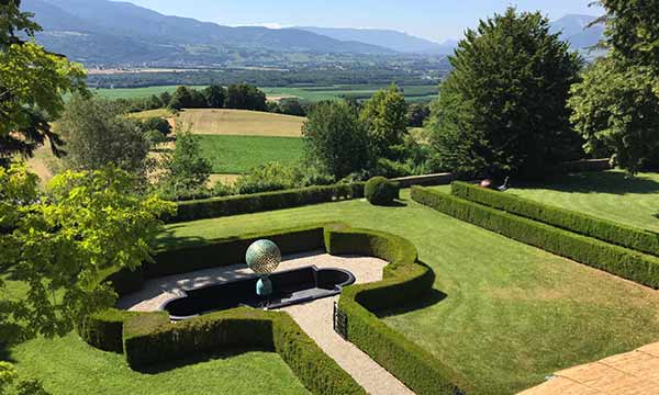 Custom water feature in formal garden with breathtaking French mountain views