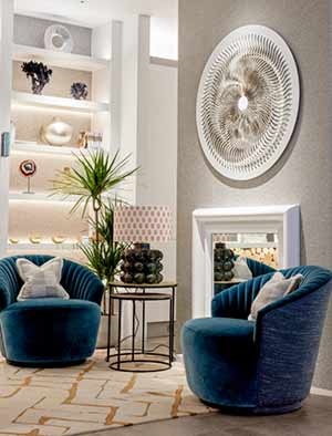 Turbine sculpture hanging over a fireplace in a contemporary styled living room