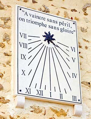 Stone wall sundial set in an old brick wall