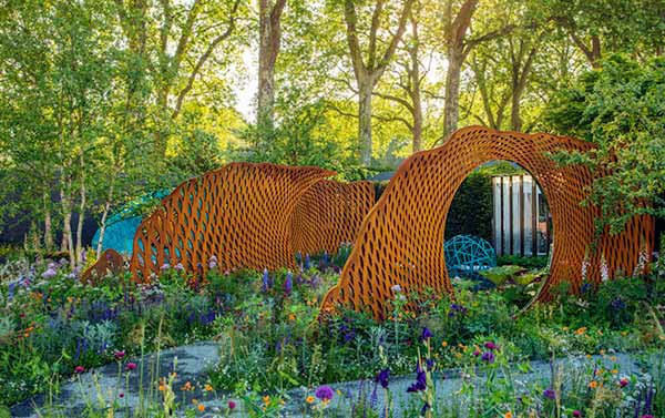 Series of screens in a woodland setting at the Chelsea Show Garden