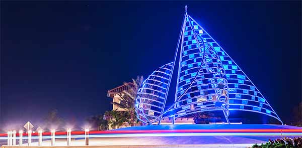 The Spinnakers, a large public sculpture, lit up at night