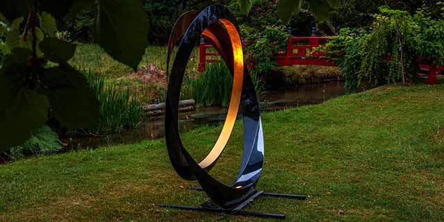 Powerful internal lighting turns Dark Planet garden sphere into a fireball