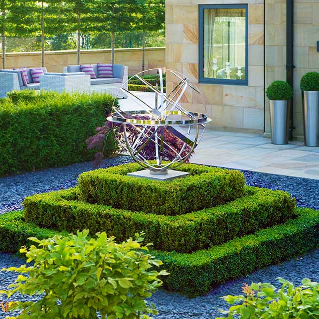 Armillary sphere on a hedged plinth