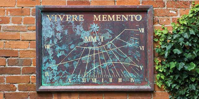 Vertical sundial on garden wall