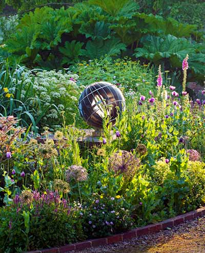 Armillary sundial amongst informal flowers