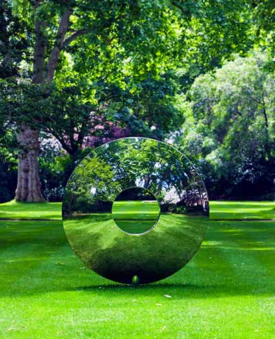 Torus sculpture with green reflections