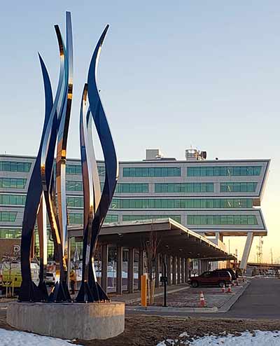 Large tree sculpture towers over its surroundings