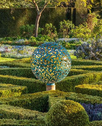 Geminus sculpture at the centre of a parterre at Helmingham Hall