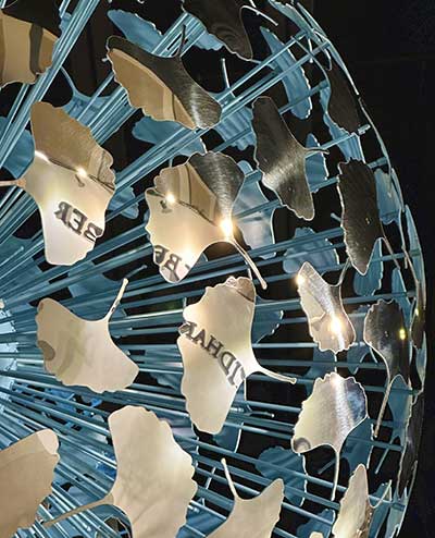 Reflection of the David Harber logo in the ginkgo petals of Messier sculpture at the Palm Beach Show 2023