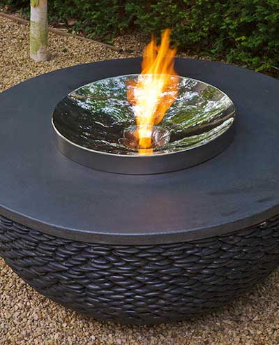Contemporary garden fire table made of black pebbles
