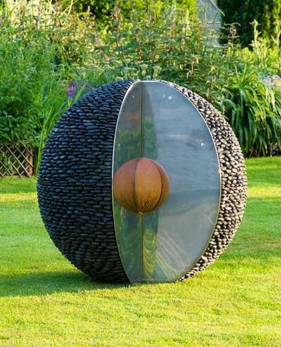 The kernel pebble sculpture bathed in the light of the setting sun