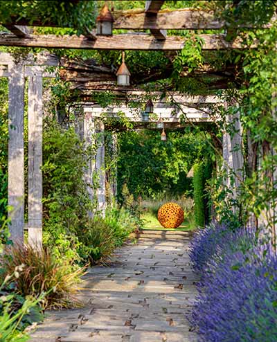 Oxidized steel Mantle II at the end of a flowery path