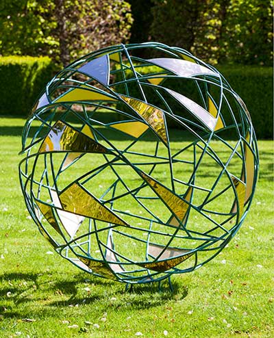 Matrix metal garden sphere on a lawn