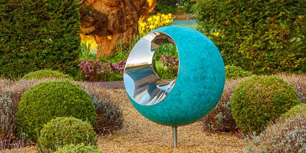 Bite copper garden sculpture with stainless steel bites taken out of it