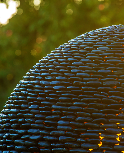 Garden sphere of smooth black pebbles