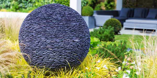 Dark Planet stone garden sphere lit up at night