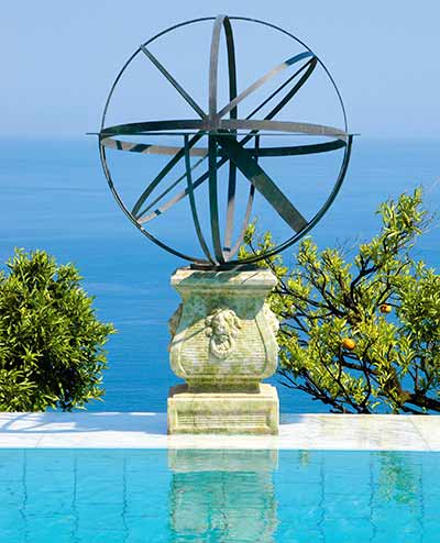 Brass armillary sundial by the sea