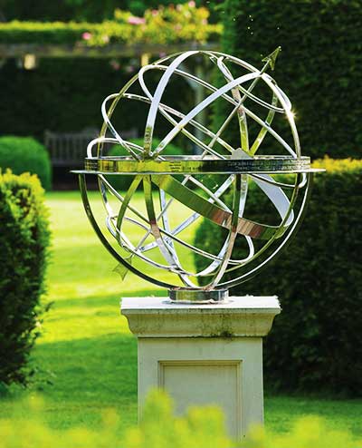 Traditional armillary sphere sundial in a contemporary garden