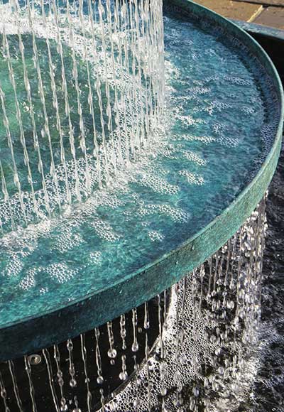 Close up of the Crucello three-tiered water fountain showing water streaming down