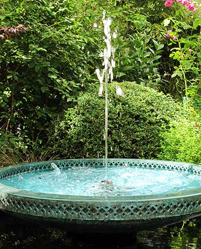 Garden art. Small bronze fountain water jet