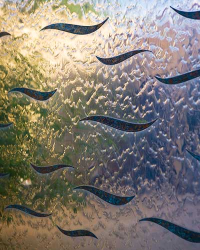 Detail of the bronze waves set into the stainless steel of the water wall